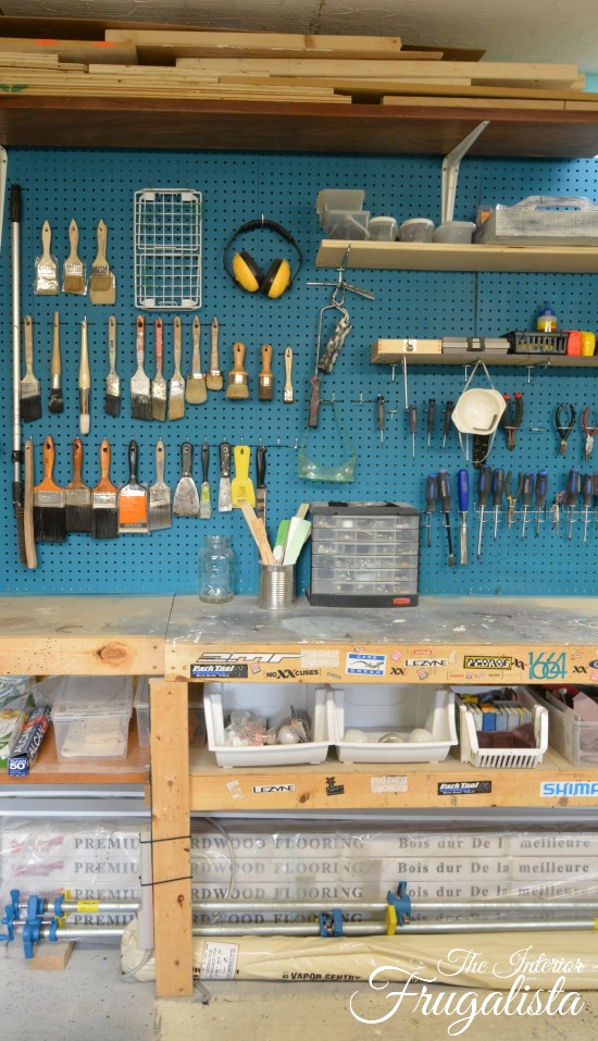 A basement workshop tour with vibrant painted pegboard walls for paint brush organization.