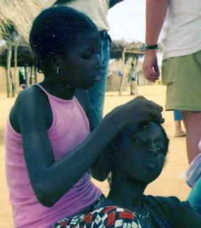 Sisters braiding hair in Senegal