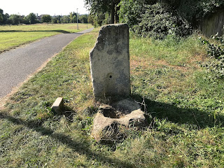 A picture showing the Plague Stone, which is a stone with a basin carved into it,  at the side of the Hob Stone.  Photo by Kevin Nosferatu for the Skulferatu Project.