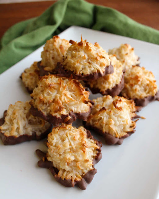 Chewy coconut filled macaroons are a simple cookie to make. The batter is super simple to make and the goodness of sweetened condensed milk is baked right in! platter of coconut macaroons with chocolate bottoms