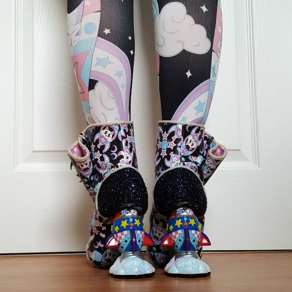 back view of legs in patterned tights with rocket shaped heeled ankle boots