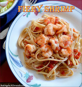Fiery Shrimp, pan sautéed, steeped in a spicy tomato sauce and tossed with fettuccine. How hot will you go? | Recipe developed by www.BakingInATornado.com | #recipe #dinner
