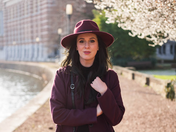 Outfit: robe coat and hat under the first spring blossoms