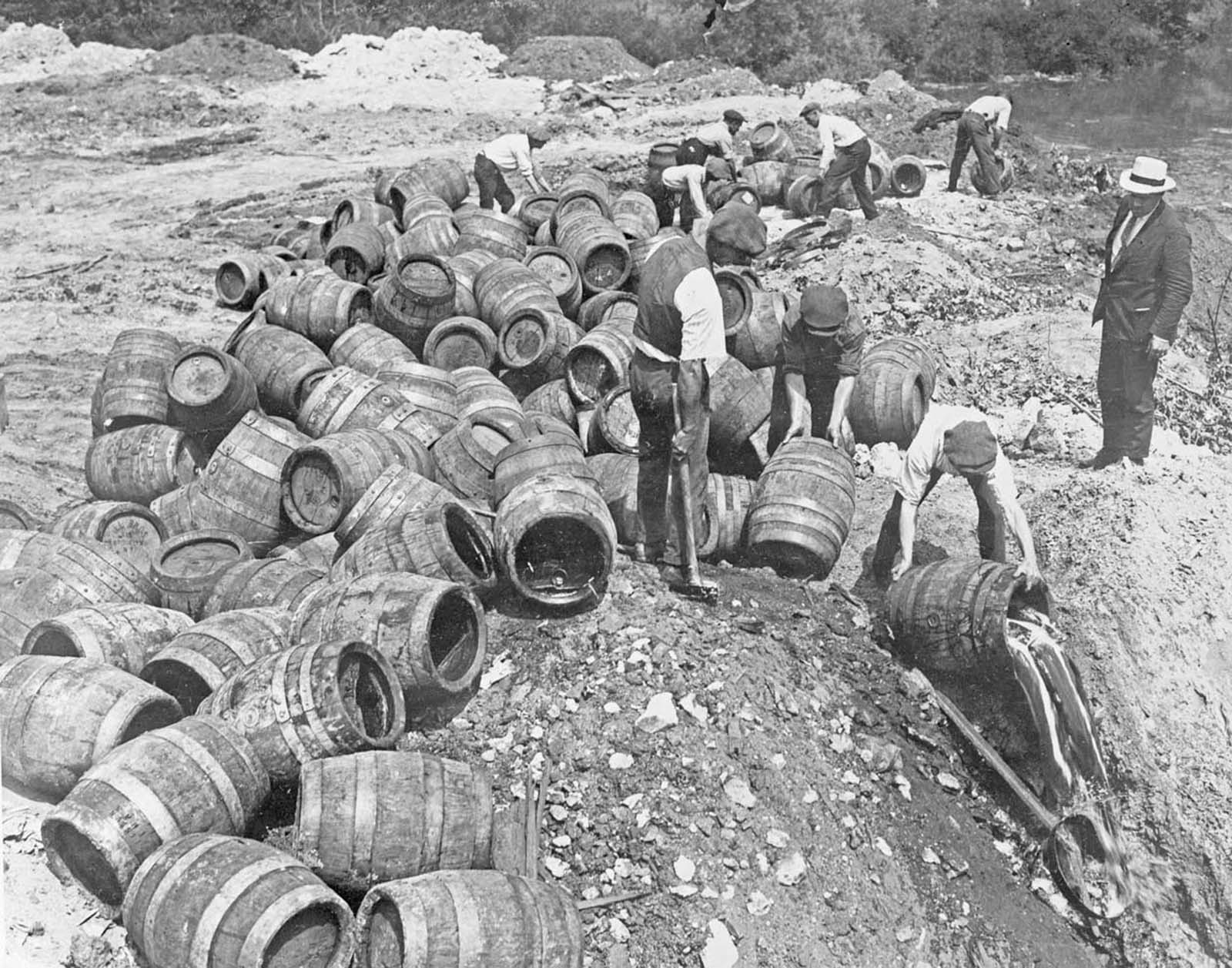 Emptying more than a hundred kegs of beer seized in a raid.