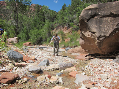 Picture of Joseph P. Fisher cooling his hat in a stream