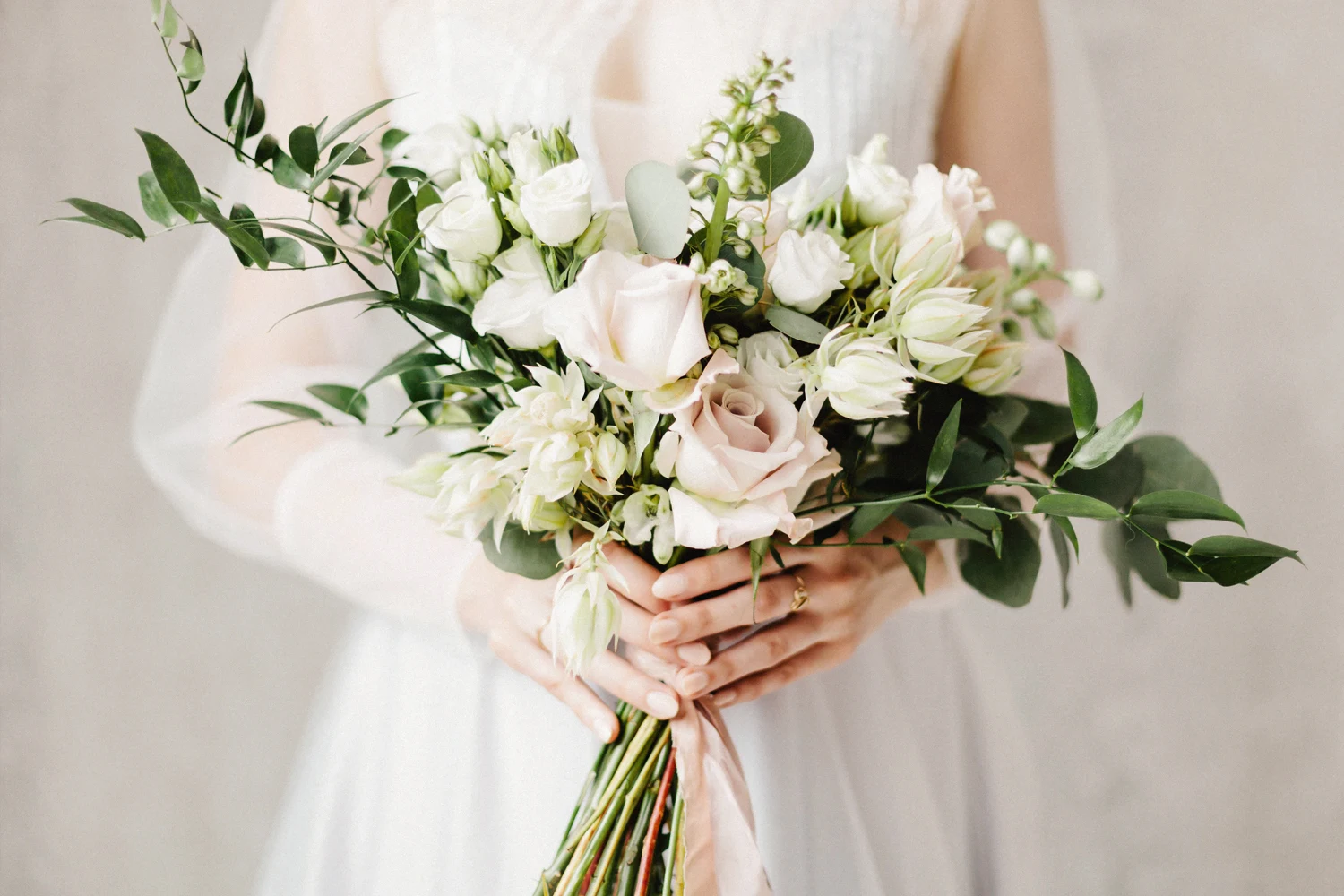 a picture of a womans hands holding fall wedding bouquet
