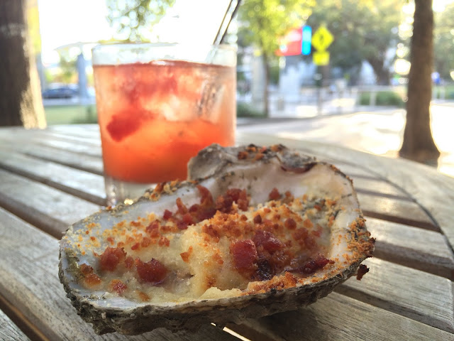 A baked Brie and Bacon oyster and Old Fashioned at Jolie Pearl Oyster Bar in downtown Baton Rouge, LA.