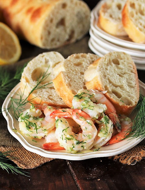 Plate of Garlic & Dill Marinated Shrimp with Baguette Slices Image