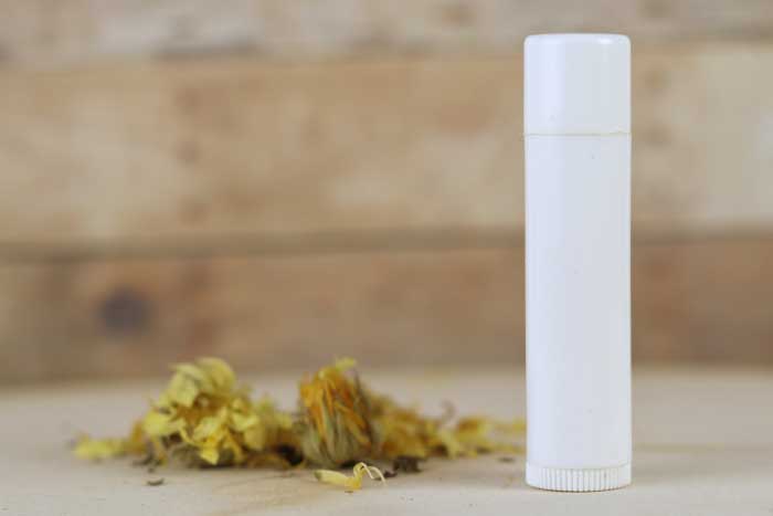 This is the best lip balm recipe!  How to make an herbal healing lip balm with calendula.  This lip balm diy is made with three types of herbs for healing.  It also has shea butter, cocoa butter, and beeswax to protect your lips. Easy home made lip balm. This lip balm recipe is easy to make.  How to make an all natural lip balm. Use beeswax lip balm to protect your lips.  Lip balm homemade recipe with herbs for natural beauty.  #lipbalm #diy #recipe #diybeauty #calendula #sheabutter #cocoabutter