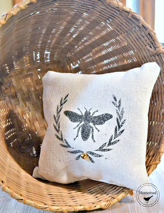 stenciled bee pillow in a basket