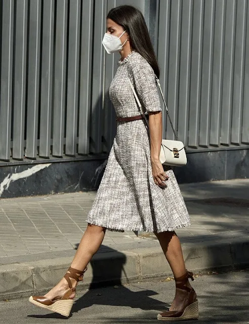 Queen Letizia wore a multicolor tweed dress from Adolfo Dominguez, and she wore tied leather wedges from Uterque