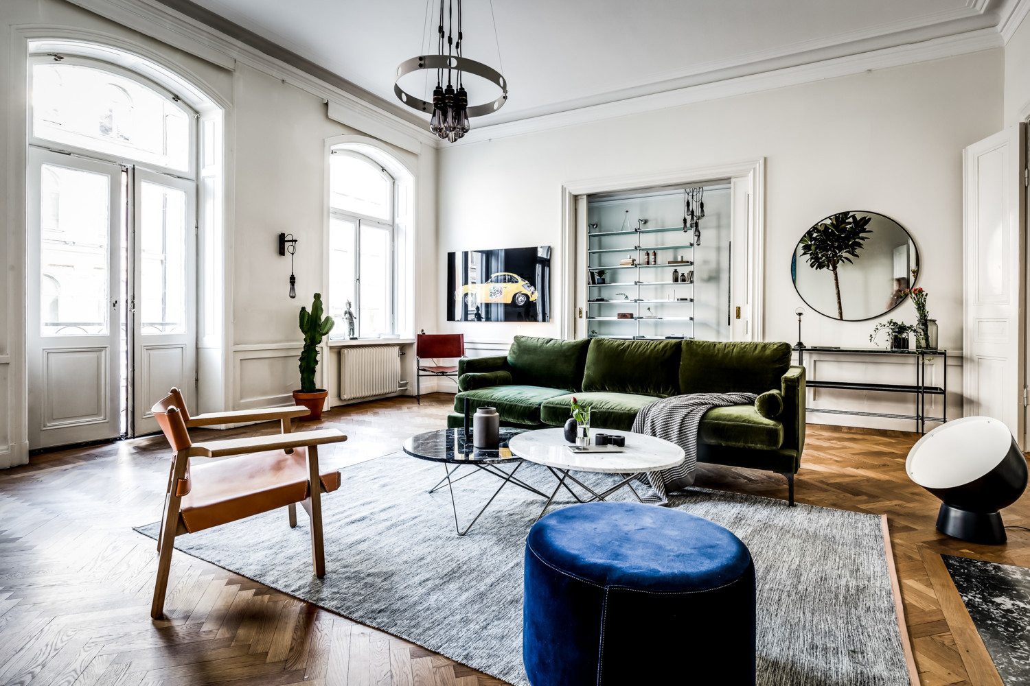 large scandinavian apartment, bohemian style living, eclectic apartment design, mid century furniture, double doors, cactus, wall art