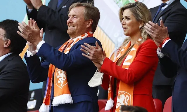 King Willem-Alexander and Queen Maxima attended the UEFA 2020 football match. Massimo Dutti orange suit, Natan, Zara red blazer