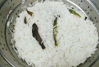 Cooked rice with spices in a stainer for veg biryani recipe