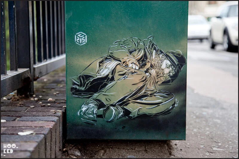 London street art, sleeping homeless man stencil by artist C215