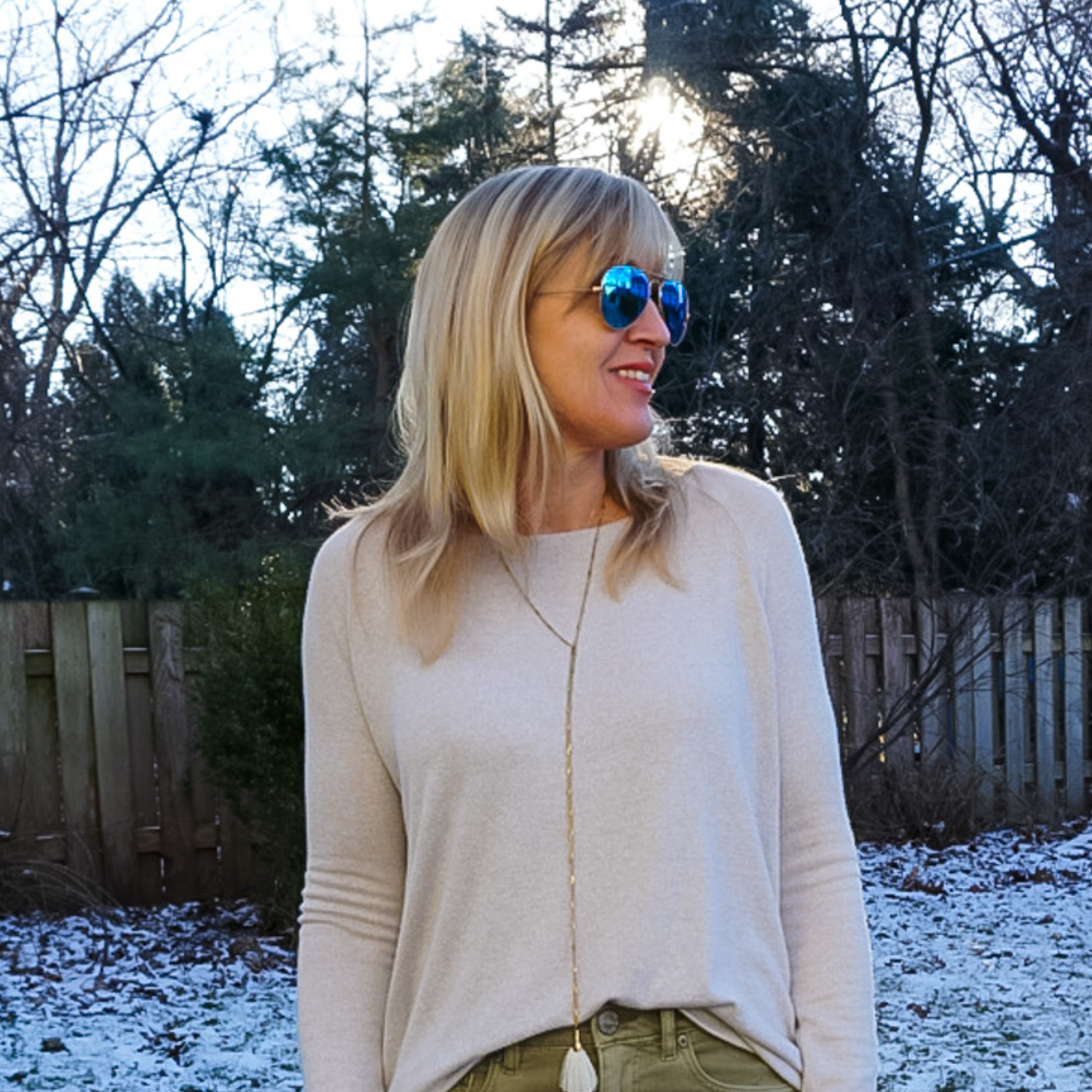 neutral sweater and lanyard necklace