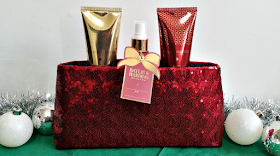 A red clutch bag holding some baylis and harding products