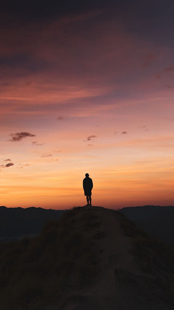 Lonely man, sunset clouds, mountain, landscape