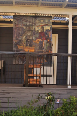 Plein air oil painting of blacksmith in the Eveleigh Railway Workshops painted by industrial heritage artist Jane Bennett