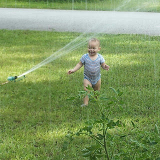 Wordless Wednesday picture of our toddler baby playing in the water sprinkler for the first time in his life