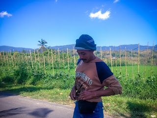 A Farmer Checking Luggage After Work While Smoking On The Roadside In The Farm Area Of The Village