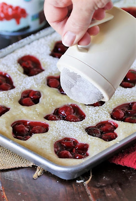 Dusting Holiday Cherry Squares with Powdered Sugar Image