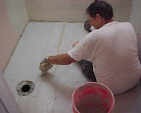 Gary is filling the edges between the bakerboard (cement) for the tile