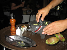 The waiter making us fresh guacamole in the Molcajete