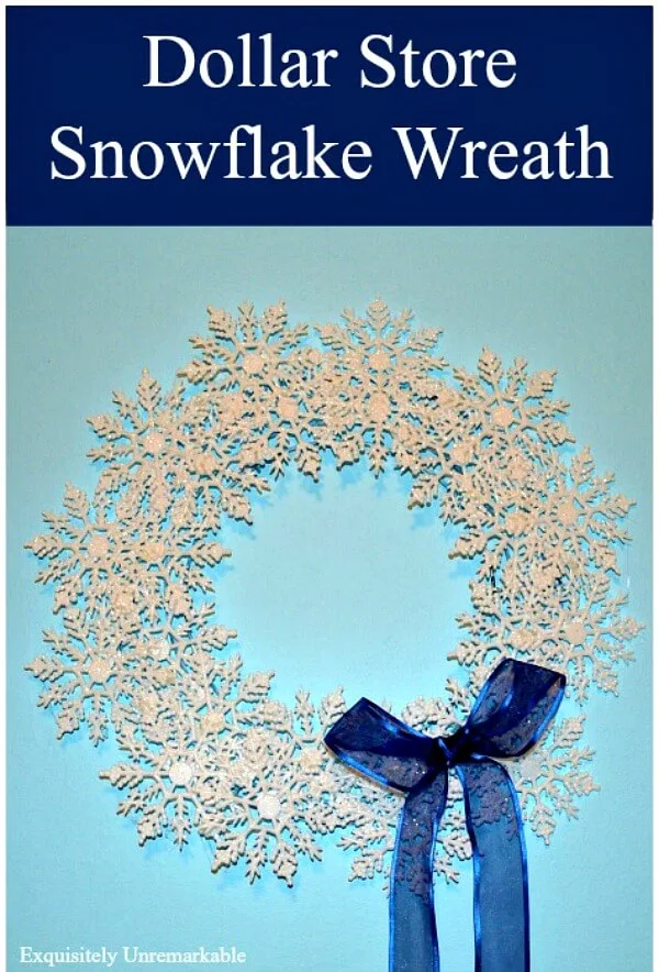 Dollar Store Snowflake Wreath DIY completed for Pinterest with blue ribbon