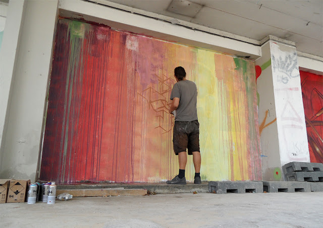 etnik working on a new street art mural in paris
