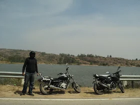 The bikes parked with a view of the Melukote temple and surroundings
