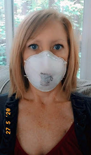 Woman with red hair wearing an N95 mask