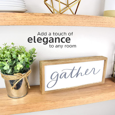A wooden sign spelling 'Gather' for kitchen decor