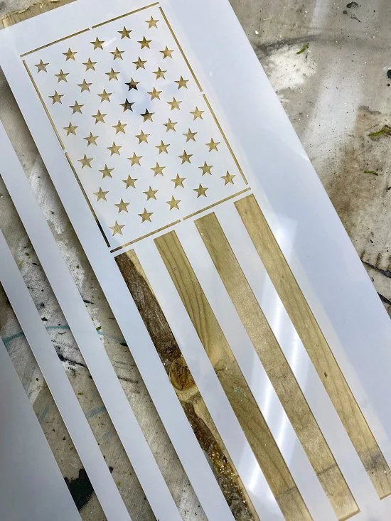 American flag stencil on a picket fence