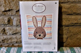 The packaging of the cross stitch kit.
