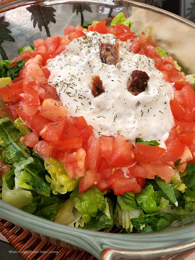 BLT Dip Recipe this is how to make BLT dip that is served in a glass pie plate it has sour cream, mayo, crumbled crispy bacon, chopped romaine and tomatoes