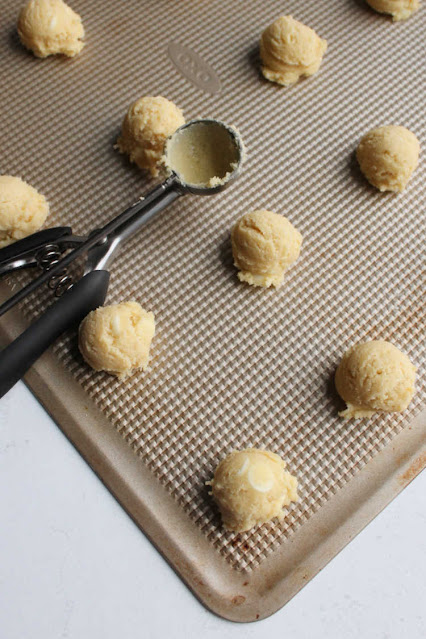 scoops of white hot chocolate mix cookie dough on tray scoops of white hot chocolate mix cookie dough on tray