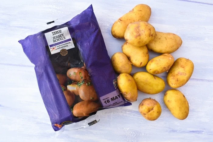 Loose Tesco Jersey Royal New Potatoes beside a full bag