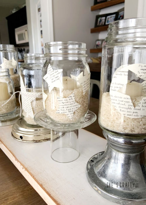 Add rice and candles to book page decorated star jars for table centerpiece