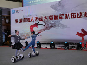 two girls dancing while on self-balancing scooters