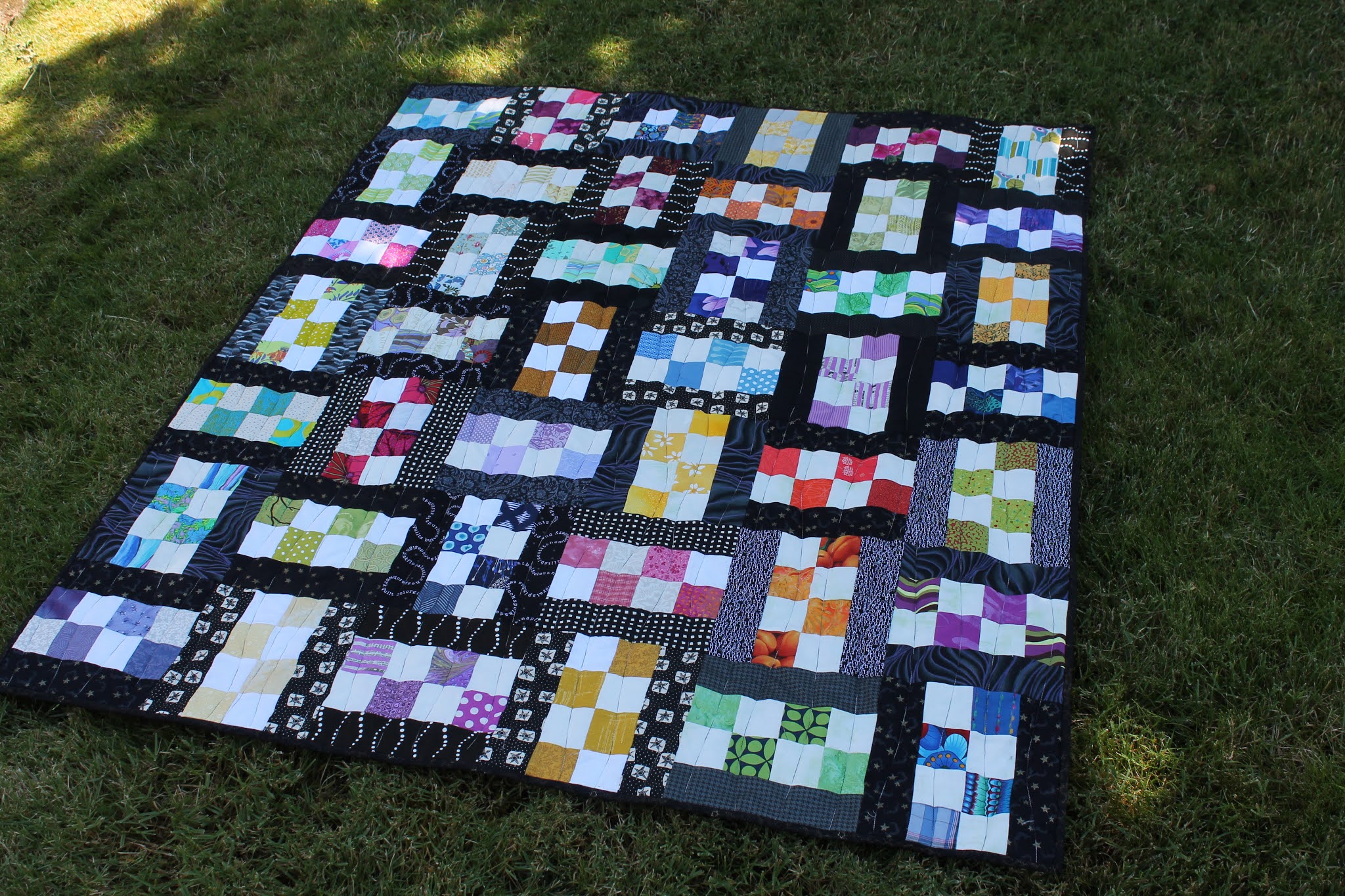 Here is an older quilt I made using the checkerboard design in rainbow colo...