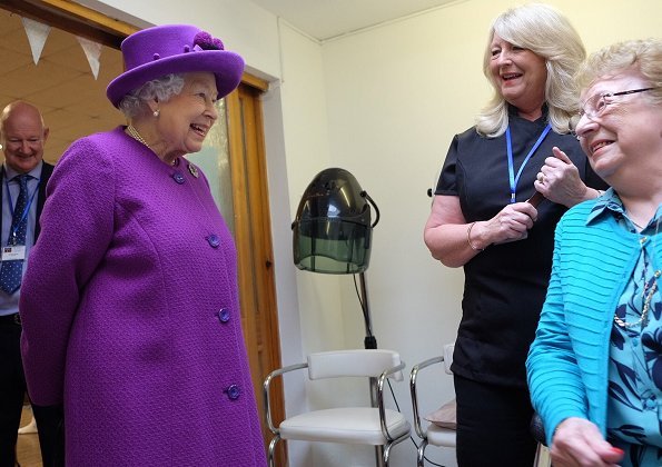 Queen Elizabeth II visited the King George VI Day Centre in Windsor. 60th anniversary of its establishment. The Queen wearing purple coat and hat