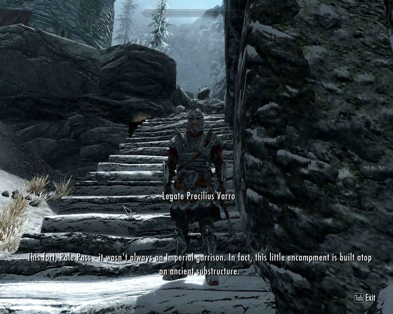a man with a heavy metal armor stands on an upward staircase telling about the structure of this fortress