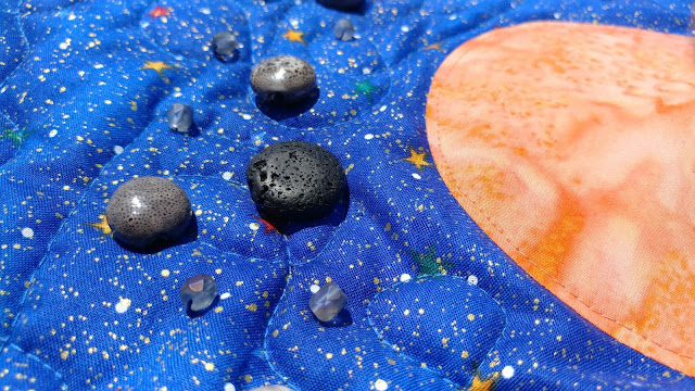Asteroids on outer space quilt