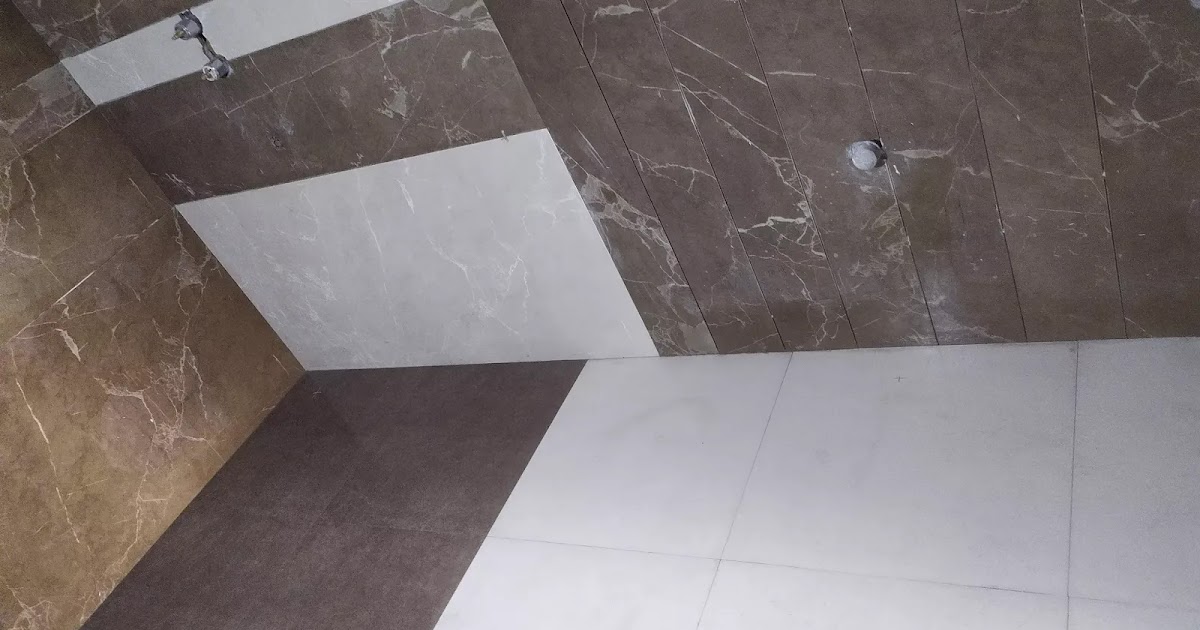 The modern bathroom tile design, big size bathroom tile work by Dhiman construction