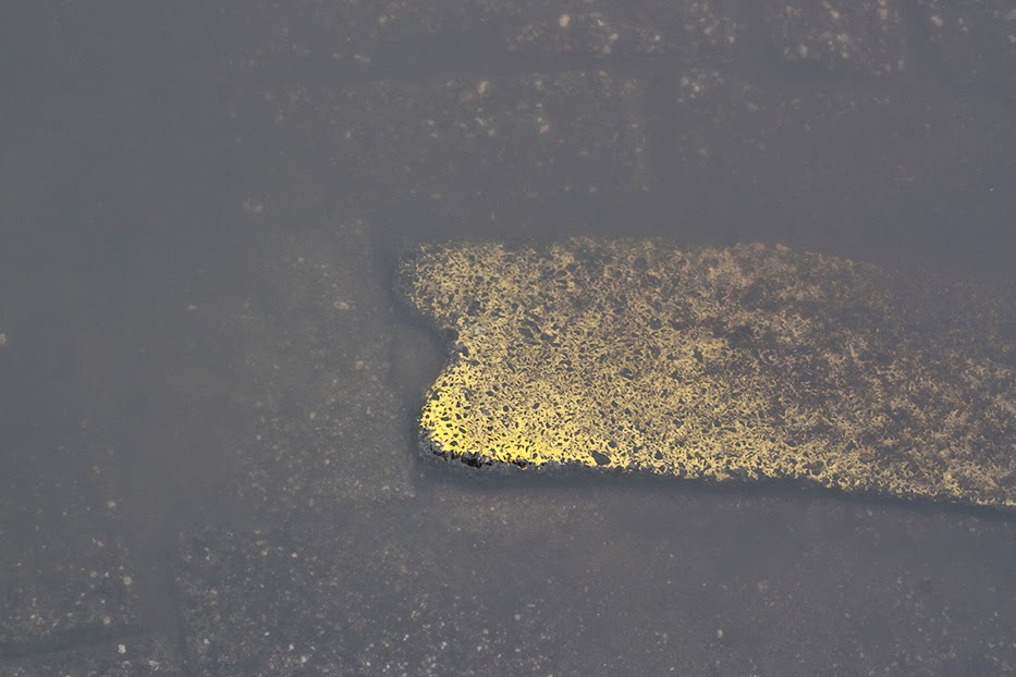 faded yellow street curb