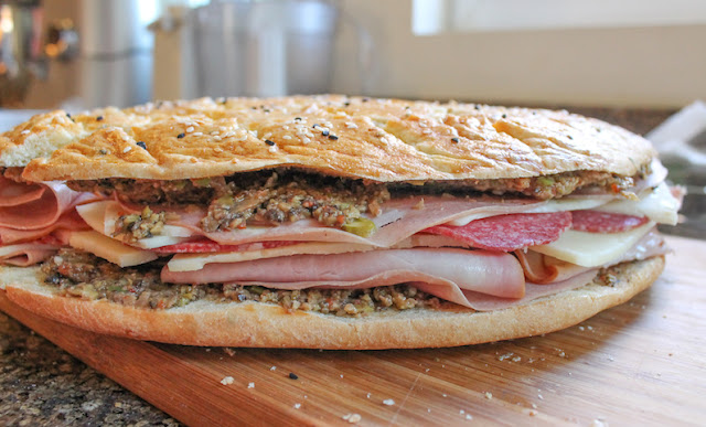 Food Lust People Love: This homemade muffuletta is my take on a popular New Orleans favorite, made with fresh olive salad, mortadella, mozzarella, salami, ham and provolone.