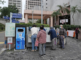 people washing their hands at an outdoor hand washing station