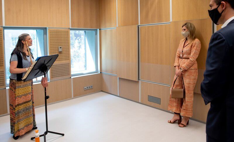 Royal Concertgebouw Orchestra in Amsterdam. Queen Maxima wore a pantsuit orange wool tweed jacket blazer and trousers from Natan