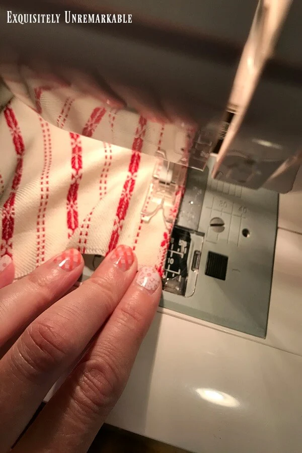 Fabric being pushed through a sewing machine